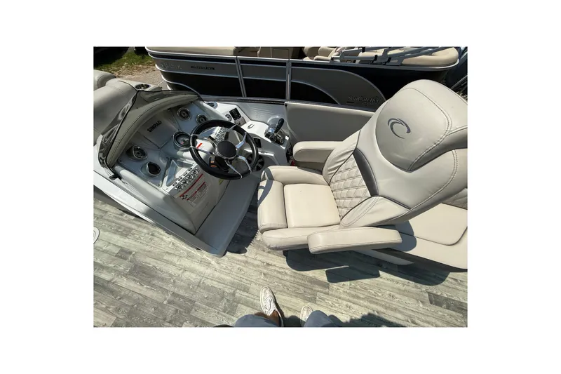 Slide: The Image of 2018 Crest Caribbean 250 SLS boat interior with steering wheel and luxurious seating. - 8