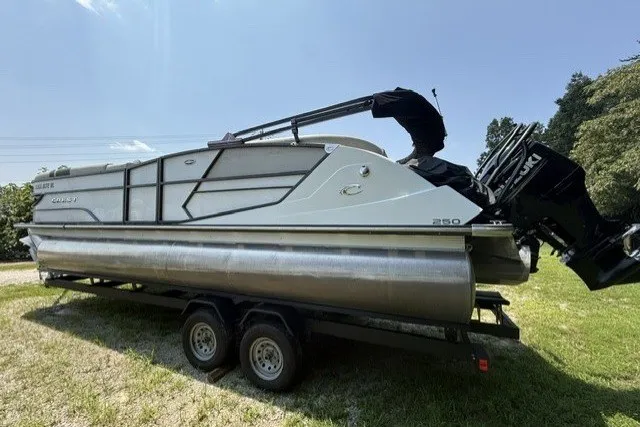 Slide: The Image of 2018 Crest Caribbean 250 SLS pontoon boat on trailer, side view, sunny day. - 3
