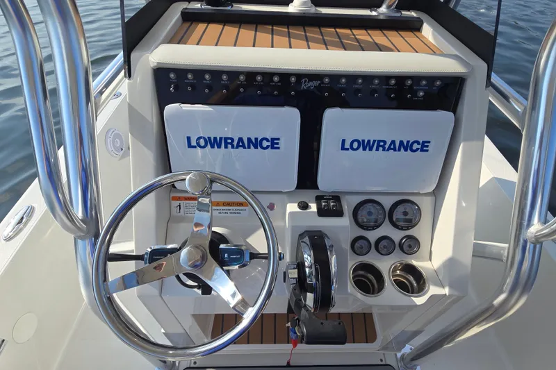 Slide: The Image of 2019 Ranger 2360 Bay Ranger boat console with Lowrance electronics and steering wheel. - 13