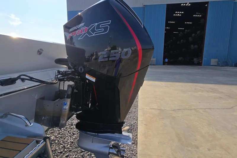 Slide: The Image of 2019 Ranger 2360 Bay Ranger with Mercury Pro XS 250 engine outside a large blue warehouse. - 11