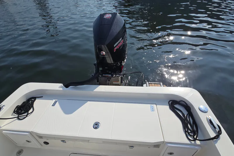 Slide: The Image of 2019 Ranger 2360 Bay Ranger boat with powerful outboard motor on calm water. - 18