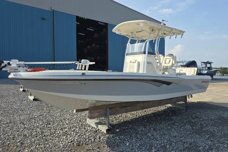 Slide: The Image of 2019 Ranger 2360 Bay Ranger boat displayed outside a blue warehouse. - 7