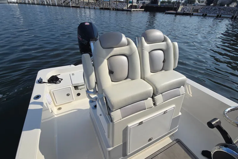Slide: The Image of 2019 Ranger 2360 Bay Ranger boat with dual seats and outboard motor on water. - 21