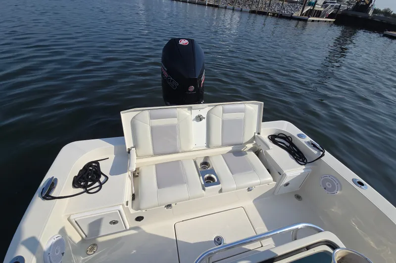 Slide: The Image of 2019 Ranger 2360 Bay Ranger boat with seating and outboard motor on calm water. - 19