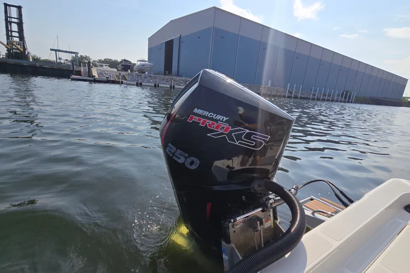 Slide: The Image of 2019 Ranger 2360 Bay Ranger with Mercury Pro XS 250 engine on water near a large building. - 32