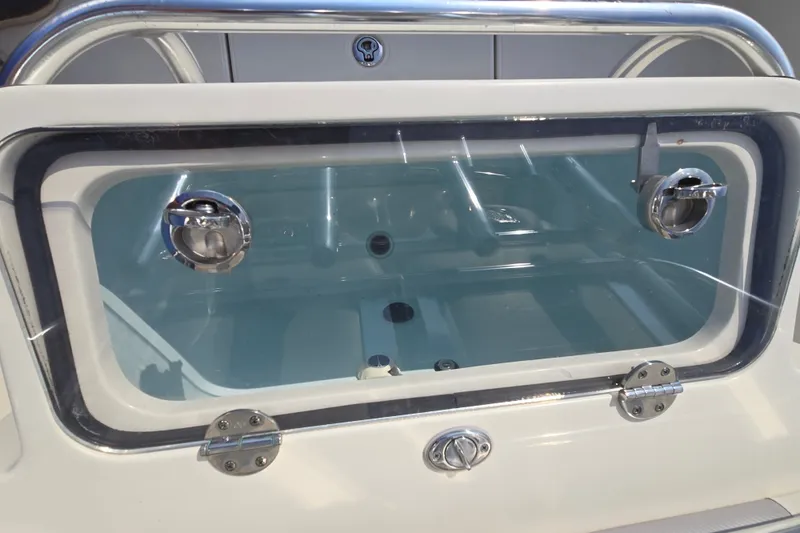 Slide: The Image of Livewell compartment on a 2019 Ranger 2360 Bay Ranger boat, featuring stainless steel hardware. - 22