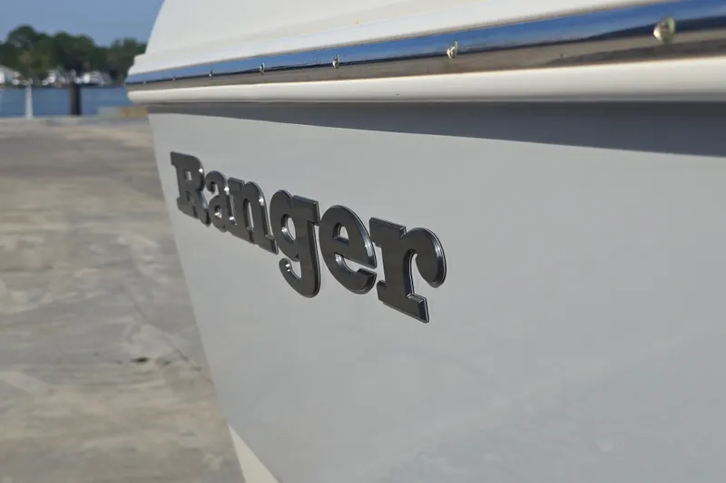Slide: The Image of 2019 Ranger 2360 Bay Ranger boat side view with logo, docked near water. - 9