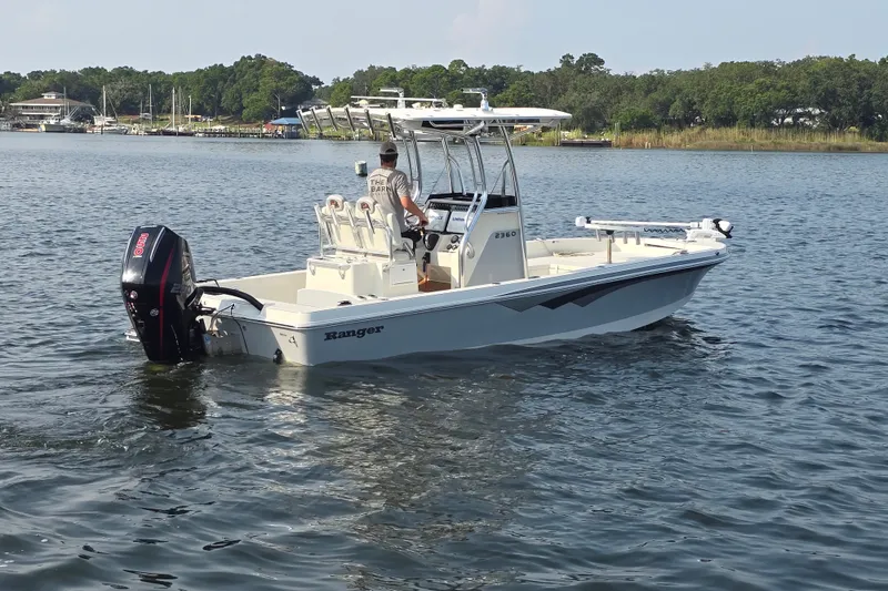 Slide: The Image of 2019 Ranger 2360 Bay Ranger boat cruising on a calm lake. - 1