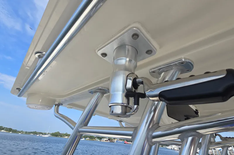 Slide: The Image of 2019 Ranger 2360 Bay Ranger boat's T-top structure with rod holder, against a clear sky. - 27