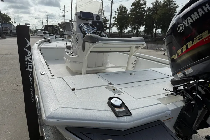 Slide: The Image of 2023 Avid 19 FS boat with Yamaha motor, displayed outdoors. - 9