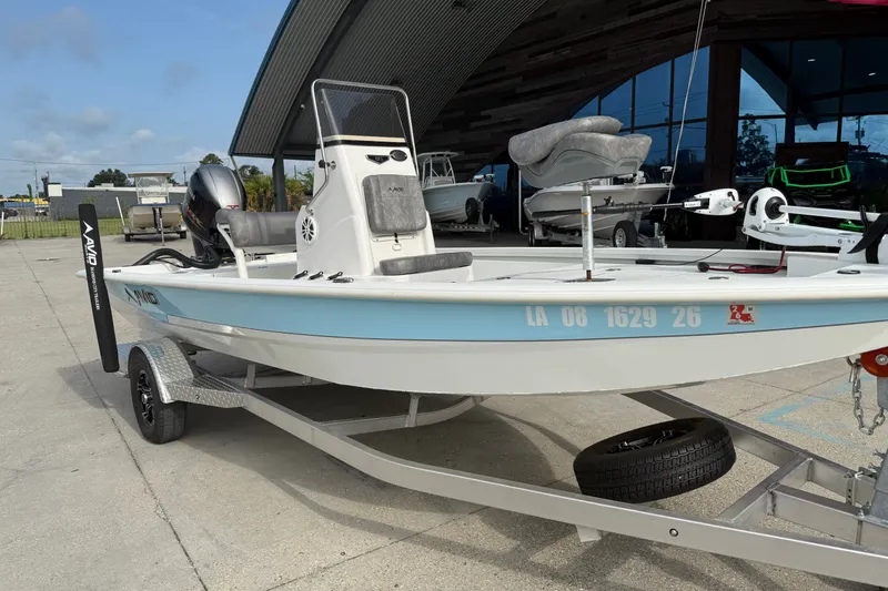 Slide: The Image of 2023 Avid 19 FS boat on trailer, displayed outdoors near a modern building. - 3