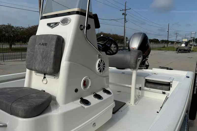 Slide: The Image of 2023 Avid 19 FS boat interior with seating and steering console. - 12