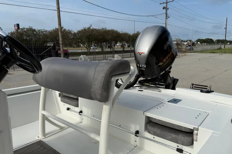 Slide: The Image of 2023 Avid 19 FS boat with Yamaha 115 engine, featuring gray seating and console. - 13