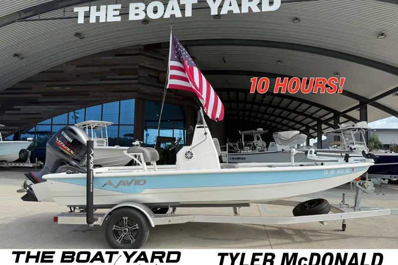 The Image of 2023 Avid 19 FS boat at The Boat Yard with American flag and Yamaha engine. - 1