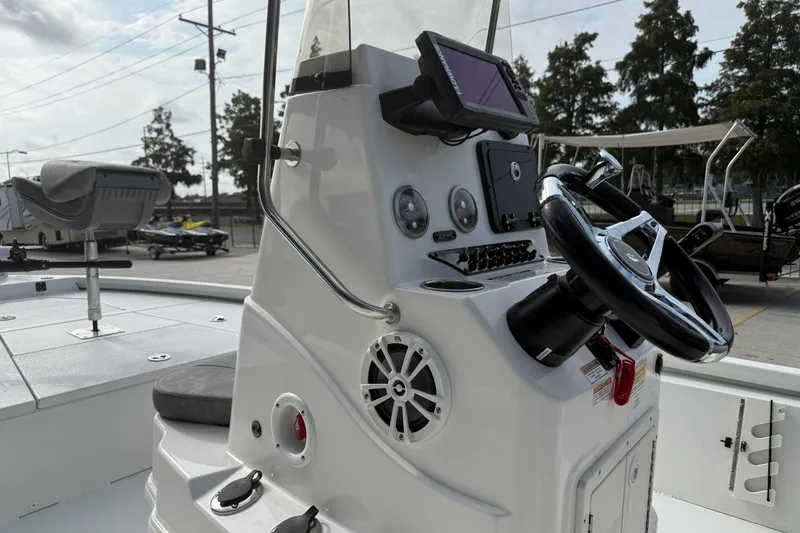 Slide: The Image of 2023 Avid 19 FS boat console with steering wheel and navigation equipment. - 14