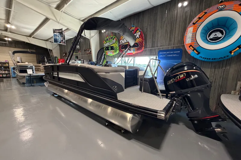 Slide: The Image of Evotti 521QL 2027 pontoon boat in showroom with Yamaha engine and inflatable water toys. - 21