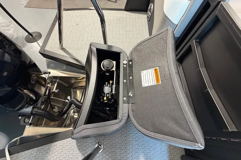 Slide: The Image of Open storage compartment in a 2027 Evotti 521QL boat, showing internal components. - 18