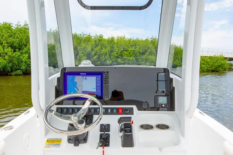 Slide: The Image of Manufacturer Provided Image: 2026 Sea Hunt BX 25 FS boat dashboard with navigation system and steering wheel. - 13