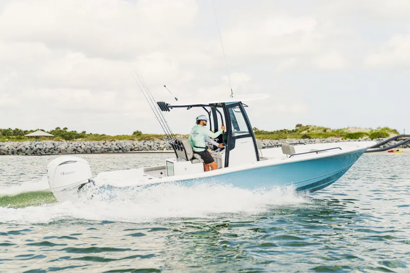 Slide: The Image of 2027 Sea Hunt BX25FS boat cruising on water, showcasing sleek design and performance. - 25