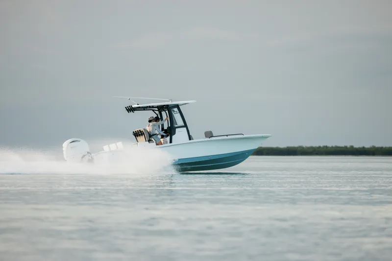 Slide: The Image of 2027 Sea Hunt BX25FS boat speeding on open water. - 8