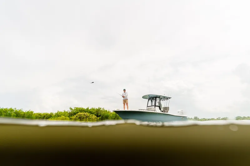 Slide: The Image of Angler fishing on a 2027 Sea Hunt BX25FS boat, partially submerged view. - 18