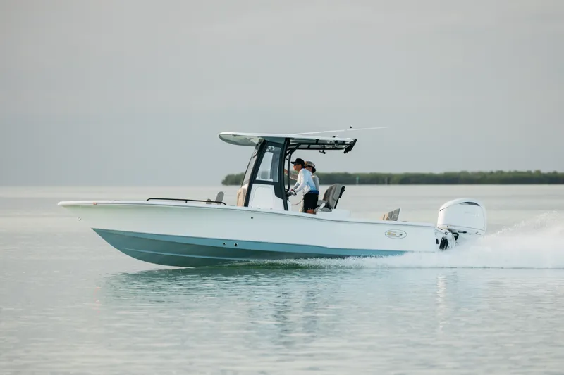 Slide: The Image of 2027 Sea Hunt BX25FS boat cruising on calm water, side view. - 48