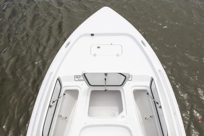 Slide: The Image of Manufacturer Provided Image: 2026 Sea Hunt BX 25 FS boat deck with open storage compartments on water. - 12