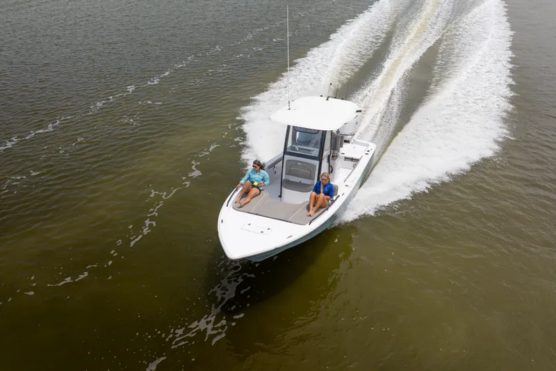 Slide: The Image of 2027 Sea Hunt BX25FS boat cruising on open water with two passengers. - 9