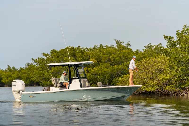 Slide: The Image of 2027 Sea Hunt BX25FS boat with anglers fishing near lush mangroves. - 4