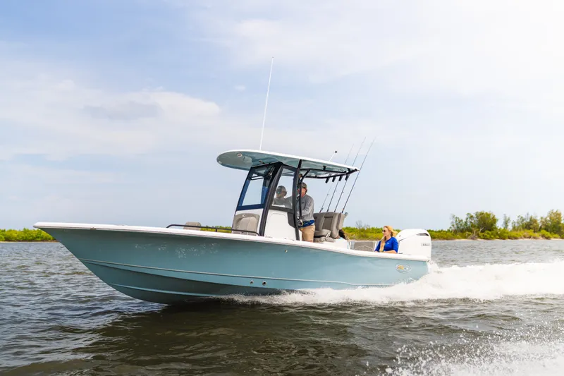 Slide: The Image of 2027 Sea Hunt BX25FS boat cruising on open water with passengers onboard. - 21