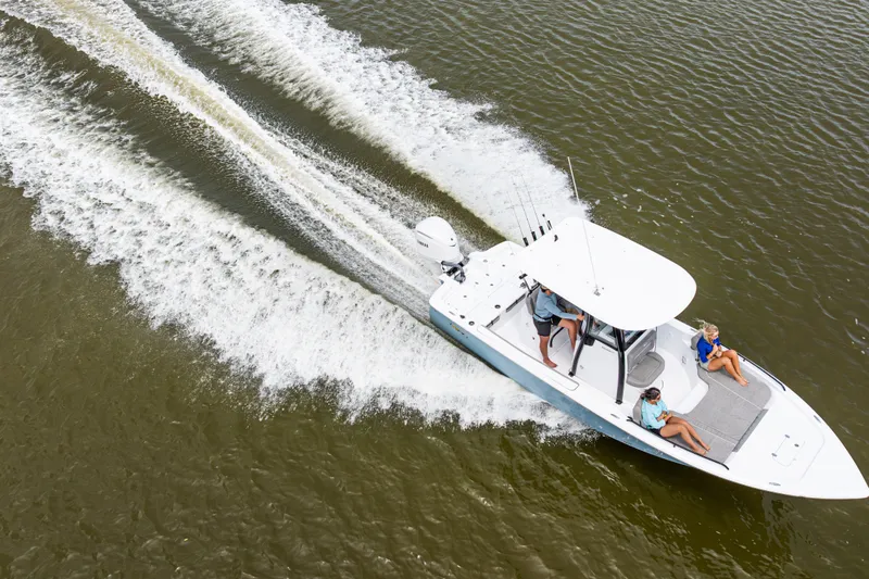 Slide: The Image of 2027 Sea Hunt BX25FS boat cruising on open water with passengers. - 29