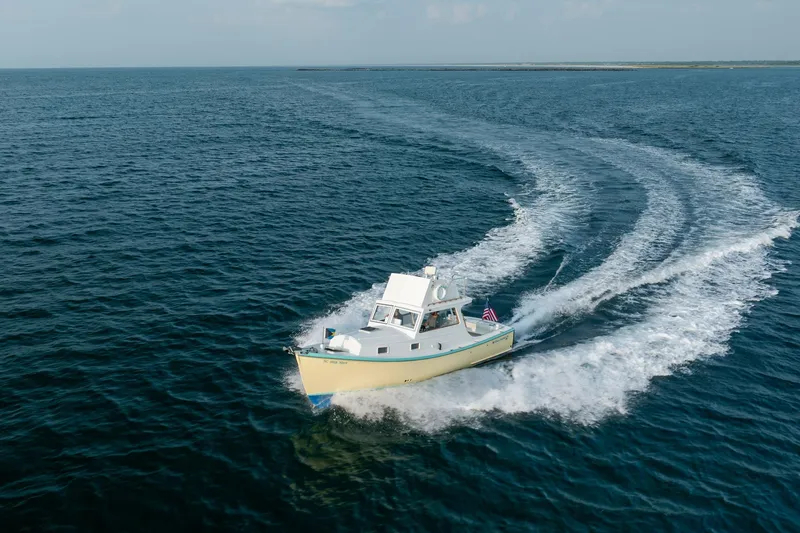 Slide: The Image of 1958 Albury Brothers boat cruising on open sea, leaving a wake behind. - 42