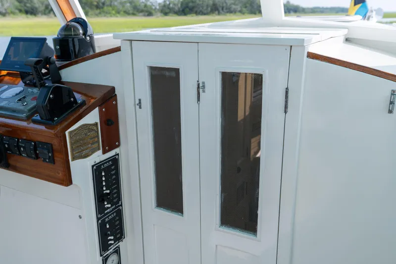 Slide: The Image of 1958 Albury Brothers boat cockpit with control panel and white cabinet doors. - 82