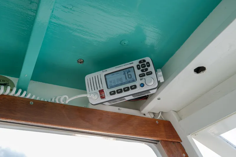 Slide: The Image of 1958 Albury Brothers boat interior with mounted marine radio under turquoise ceiling. - 60