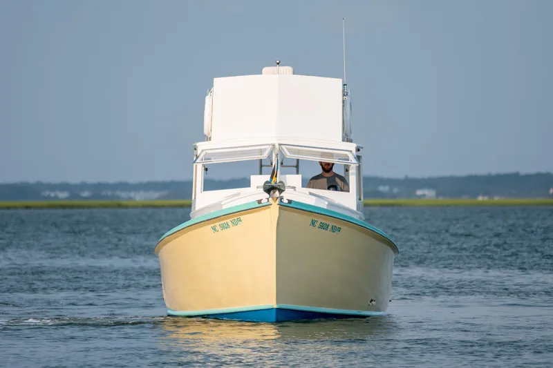 Slide: The Image of 1958 Albury Brothers boat cruising on calm waters, front view. - 14
