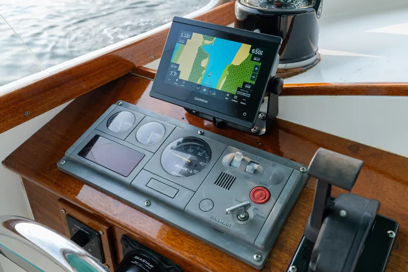 Slide: The Image of 1958 Albury Brothers boat dashboard with Garmin navigation system and vintage controls. - 57