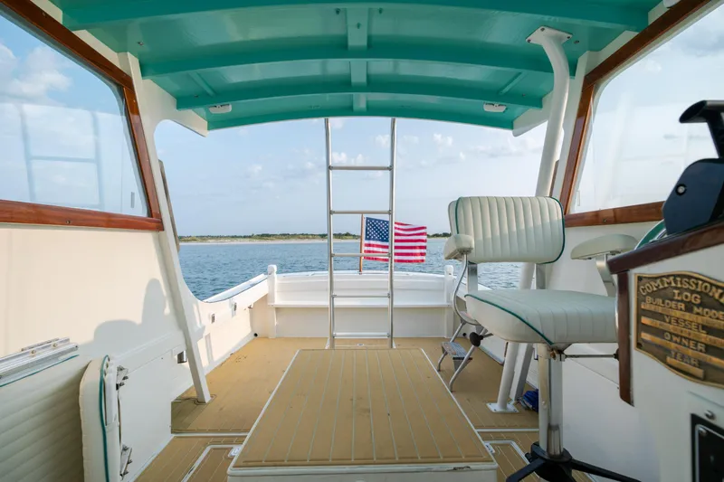 Slide: The Image of Interior of a 1958 Albury Brothers boat with American flag and ocean view. - 61