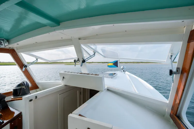 Slide: The Image of 1958 Albury Brothers boat interior with a view of the water and a flag. - 63