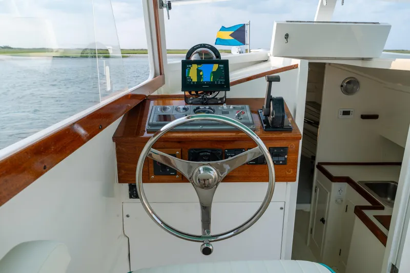 Slide: The Image of 1958 Albury Brothers boat helm with wooden accents and navigation equipment. - 58