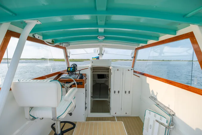 Slide: The Image of Interior of a 1958 Albury Brothers boat with turquoise ceiling and wooden accents. - 55