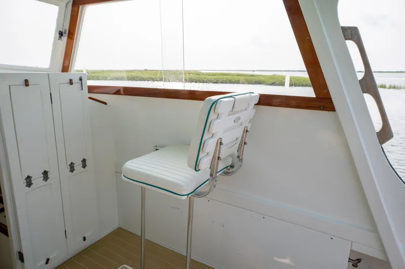 Slide: The Image of 1958 Albury Brothers boat interior with white seating and wooden accents. - 71