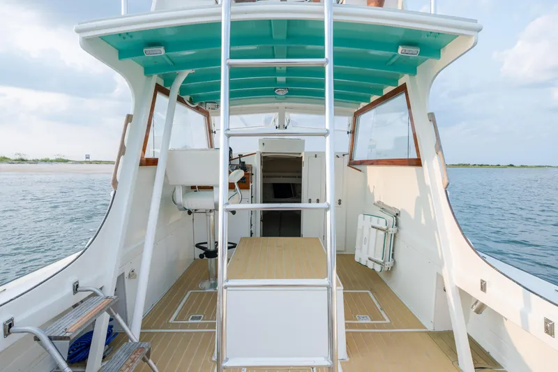 Slide: The Image of 1958 Albury Brothers boat interior with ladder, turquoise ceiling, and ocean backdrop. - 52