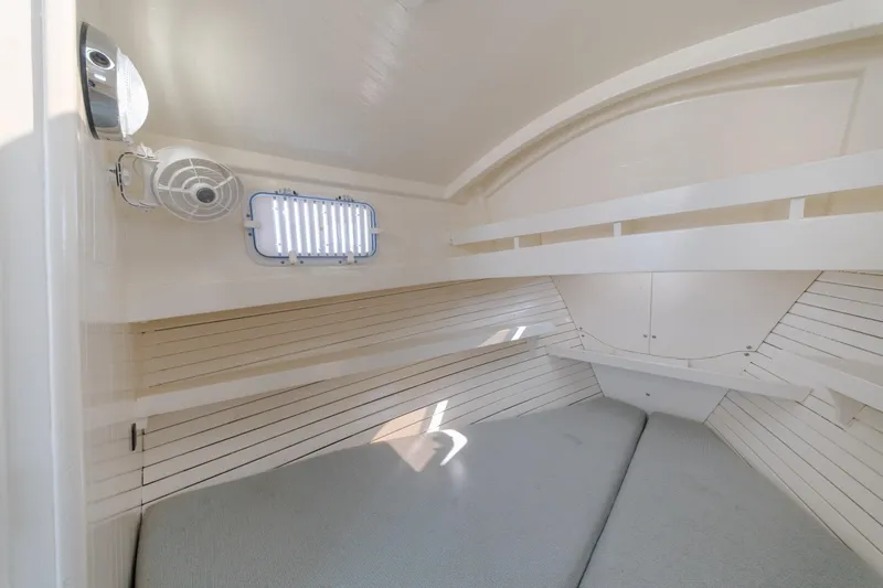 Slide: The Image of Interior cabin of a 1958 Albury Brothers boat, featuring a cozy sleeping area. - 76