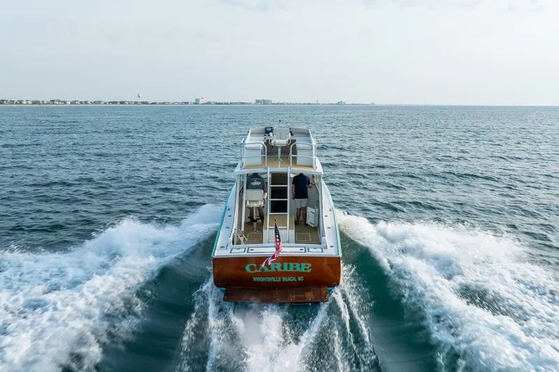 Slide: The Image of Albury Brothers 1958 boat cruising on open sea, rear view with wake trails. - 39