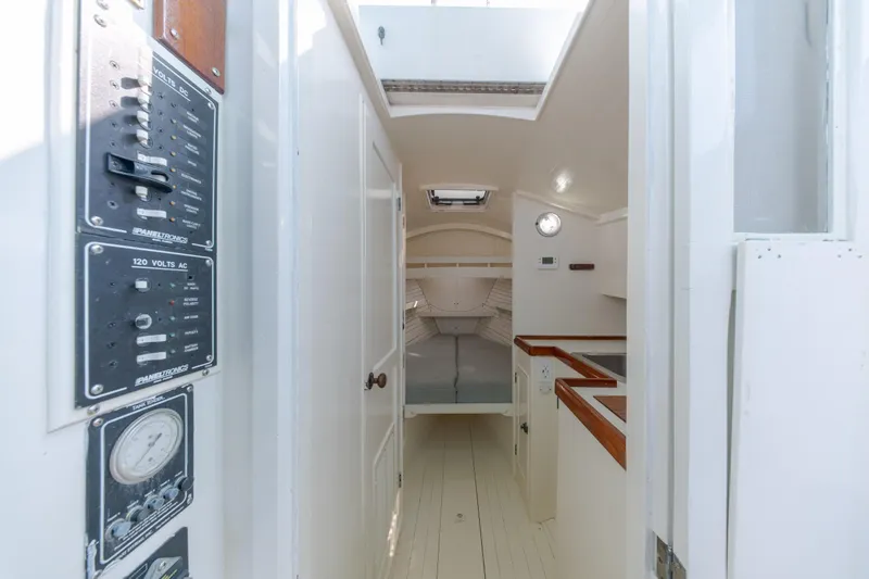 Slide: The Image of Interior of a 1958 Albury Brothers boat, featuring control panels and a cozy cabin space. - 73