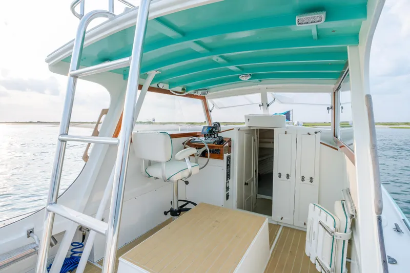 Slide: The Image of 1958 Albury Brothers boat interior with turquoise ceiling, steering wheel, and storage cabinets. - 53