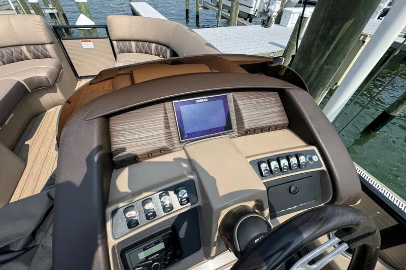 Slide: The Image of 2022 Bennington 23 LXFB boat dashboard with controls and navigation screen. - 17