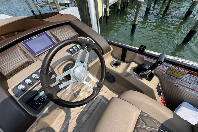 Slide: The Image of 2022 Bennington 23 LXFB boat helm with steering wheel and control panel. - 18