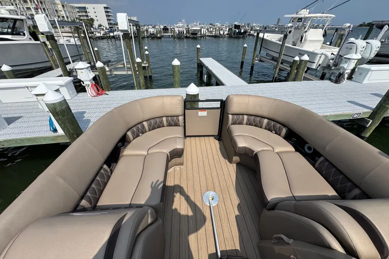 Slide: The Image of 2022 Bennington 23 LXFB pontoon boat interior at marina dock. - 13