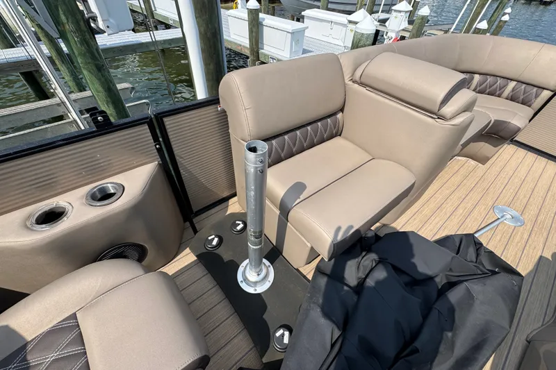 Slide: The Image of 2022 Bennington 23 LXFB boat interior with beige seating and cup holders. - 20